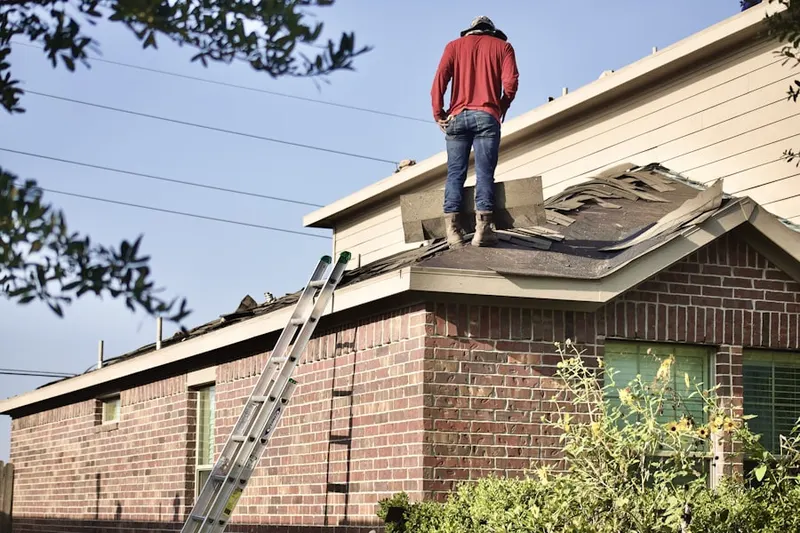 Professional roofer working on a residential roof in Olde Village